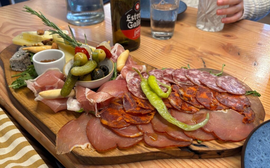 Selection of tapas served on a wooden board at CATA restaurant in Stockbridge, Edinburgh.