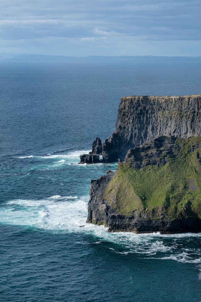 Breathtaking aerial view of Moher Cliffs along Ireland's dramatic coastline, showcasing natural beauty and grandeur.