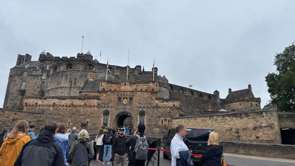 Edinburgh Castle entrance as seen from approach with people waiting outside to enter