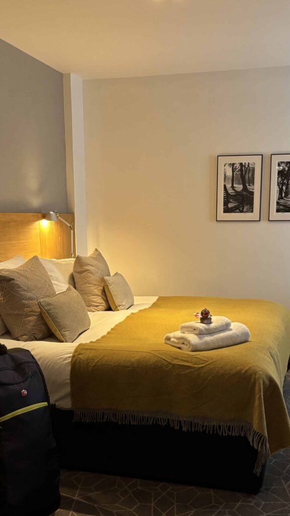 room interior at the apex waterlook hotel in edinburgh near waverley station with a king bed and soft lighting.