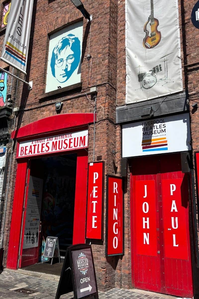 Front entrance of The Beatles Museum on Mathew Street, Liverpool with red signage.