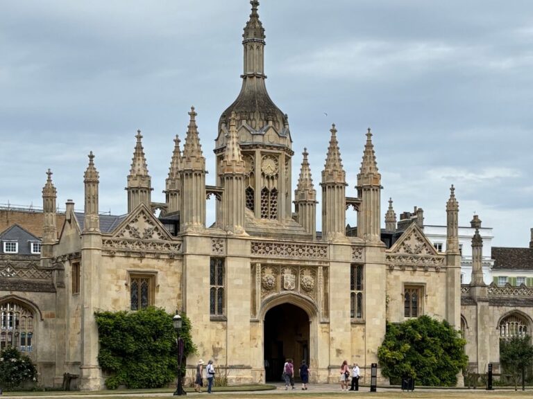 View of King’s College Chapel in Cambridge, England, showcasing its historic architecture under a cloudy sky.