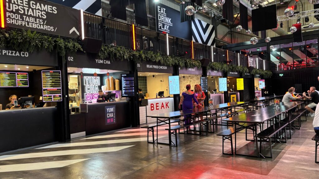 Inside of BOXPARK Liverpool in the Baltic Triangle showing different food stalls and communal seating.