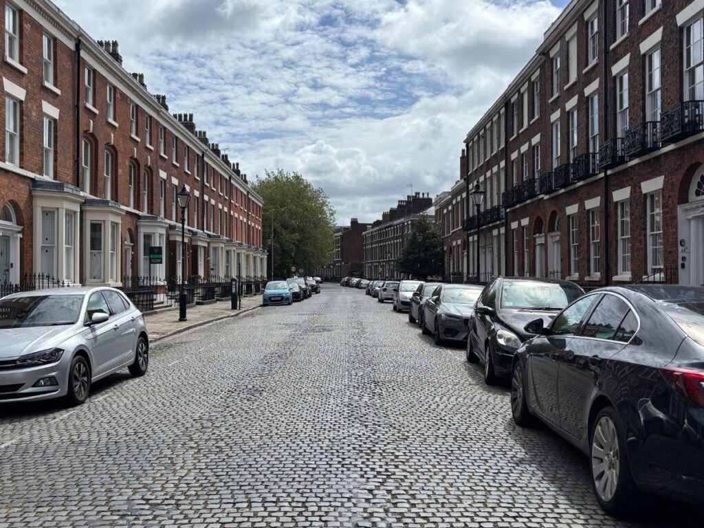 Classic cobblestone streetscape in Liverpool's Georgian Quarter with evidence of where the original tram once ran.
