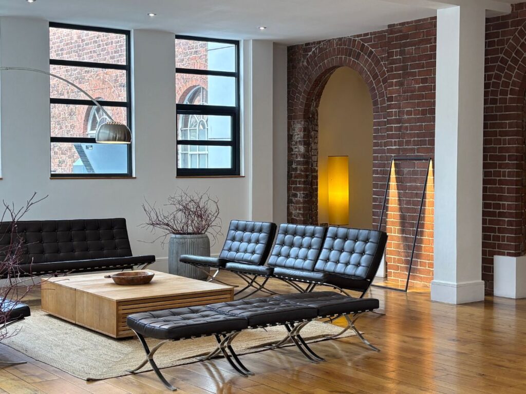Interior lobby of Hope Street Hotel in Liverpool's Georgian Quarter with central lounge area and red brick arch architectural details.