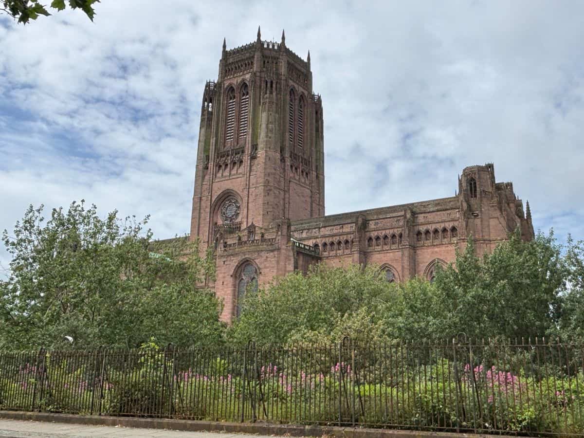 Liverpool's Anglican Cathedral built from local sandstone, viewed from the corner of Canning Street in the Georgian Quarter, with gardens and greenery in the foreground