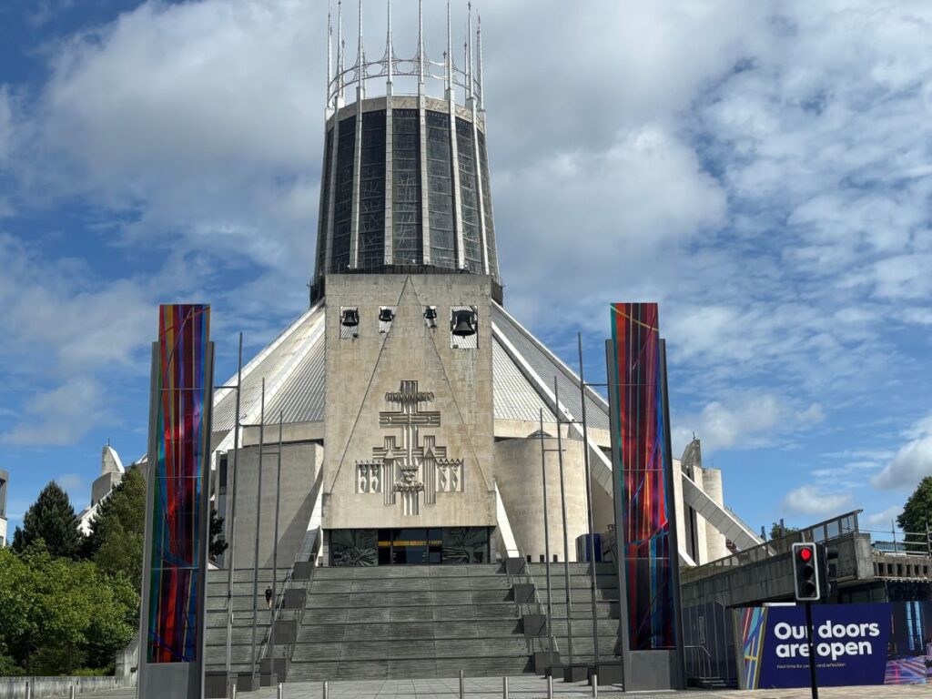 Metropolitan Cathedral in Liverpool's Georgian Quarter as seen looking north down Hope Street with the grey wigwam-style modernist architecture against a cloudy sky as backdrop.
