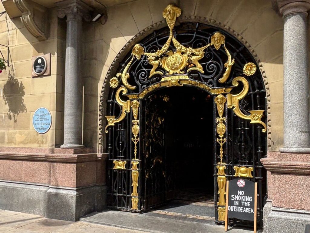 Ornate black and gold ironwork at the entrance to the Philharmonic Pub on Hope Street, Liverpool