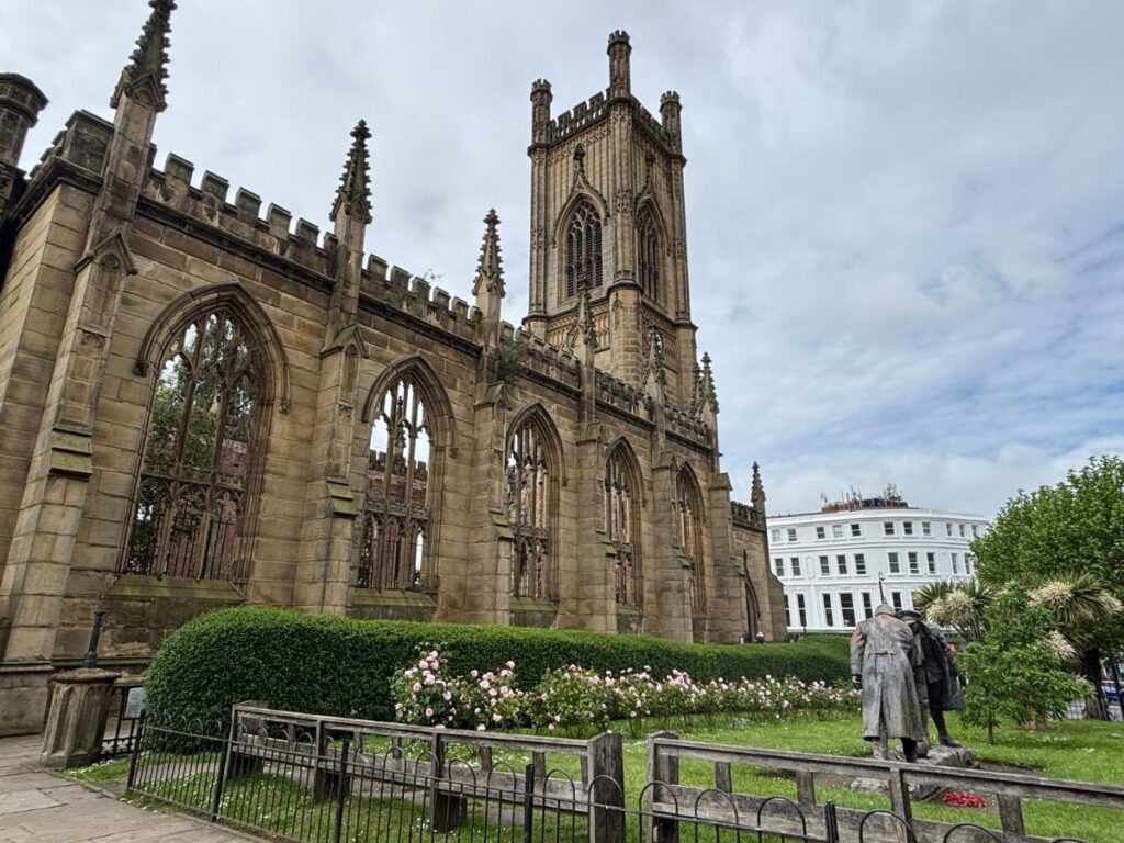 Church ruins at St. Lukes Liverpool with tower and classic architecture against cloudy sky.