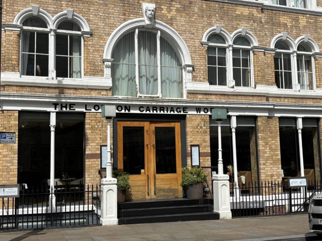 Facade of The London Carriage House restaurant in Liverpool's Georgian Quarter with wooden double arched doorway and original Victorian-era architectural details.