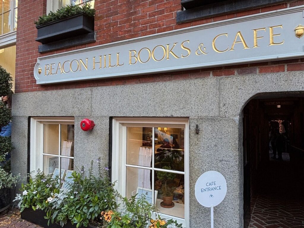 Front entrance to Beacon Hill Books & Cafe with gold signage.