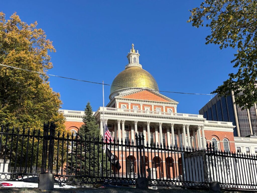 Gold dome of Massachusetts State House as seen from Boston Common in Beacon Hill.
