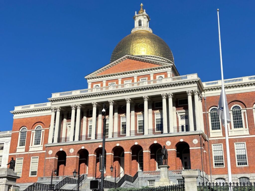 Massachusetts State House with gold dome gleaming in bright fall sunlight in Boston.
