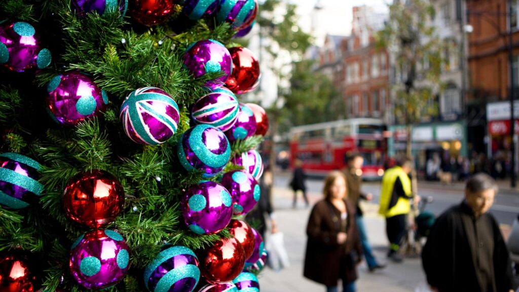 Christmas in London streetscene with festive garland and colorful baubles.
