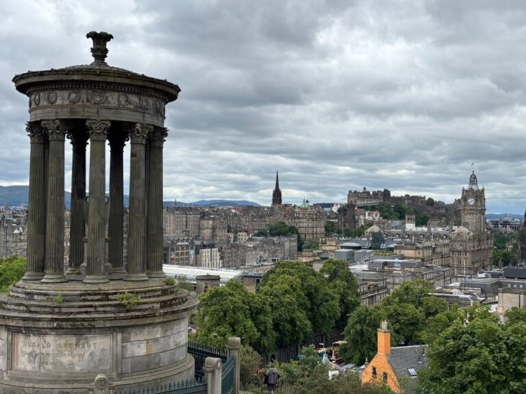View from Calton Hill across Edinburgh skyline on a cloudy day.