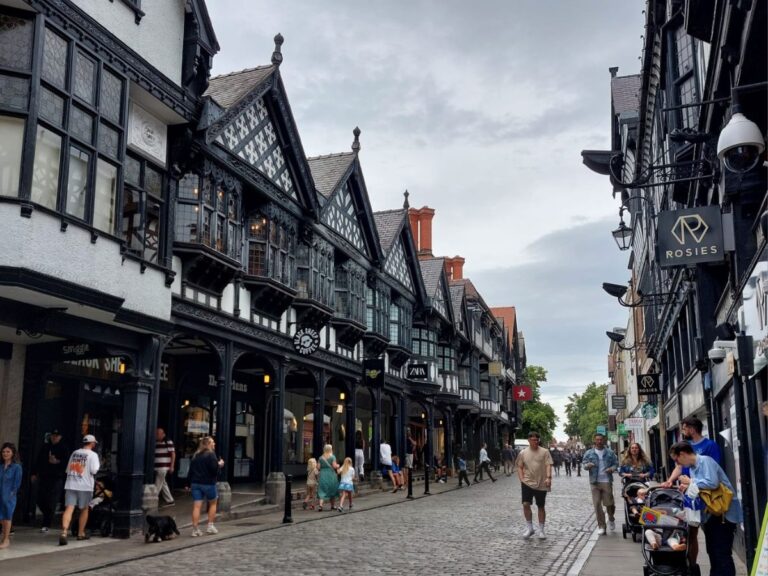 Streetscape of Northgate in Chester, England with unique "rows" on either side of central cobbled street featuring distinctive black and white timber architecture