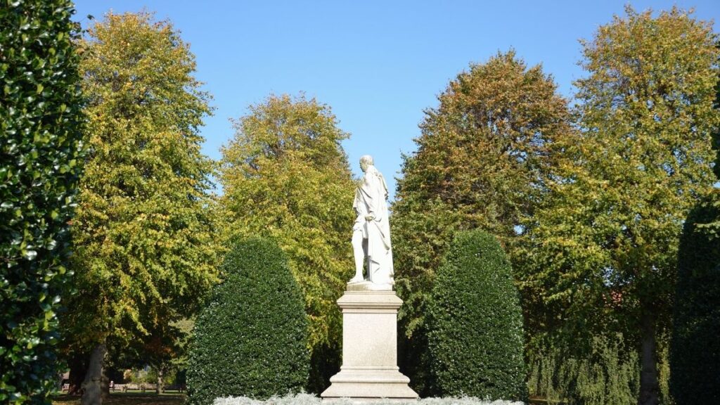 Side view of the 2nd Marquess of Westminster statue in Grosvenor Park, one of the scenic things to do in Chester, with blue sky behind.