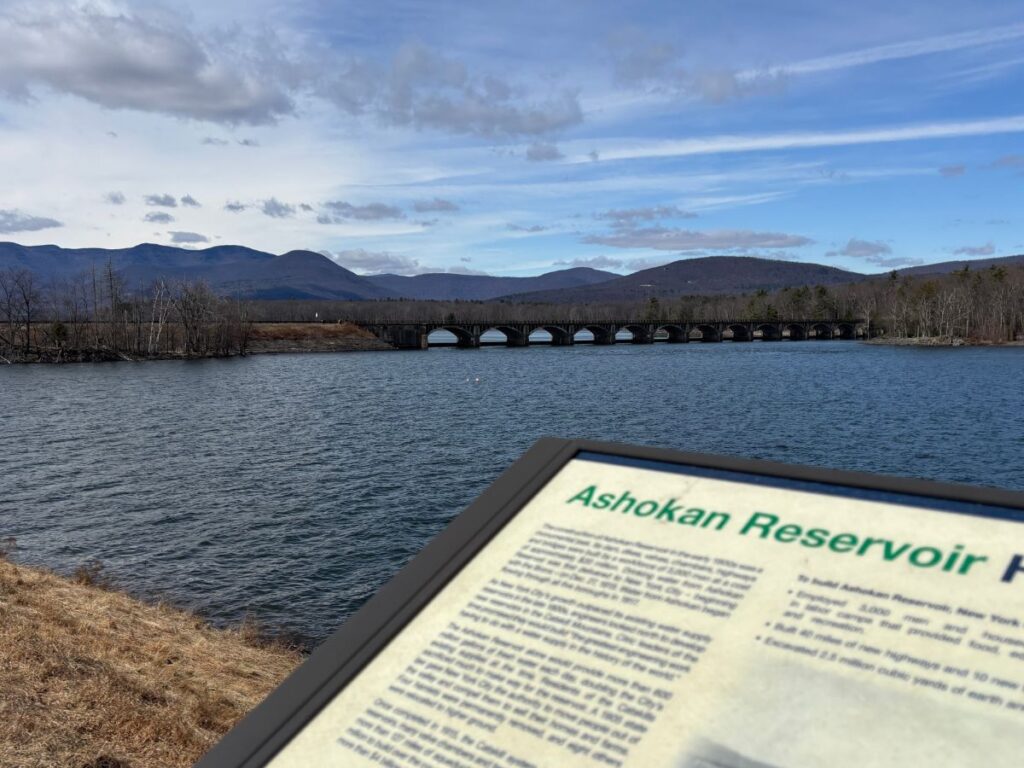 Ashokan Reservoir with the Catskill Mountains in the background and tourist information board in the foreground, NY