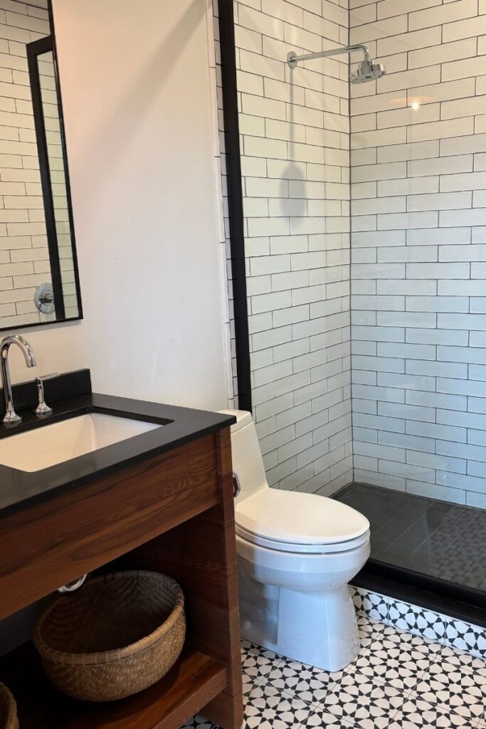White subway tile in contemporary bathroom with black and white decor theme.