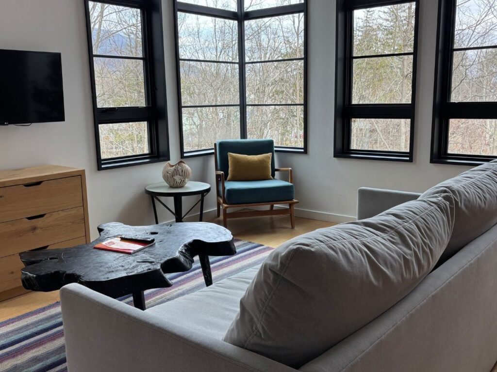 Interior of King Suite at Woodstock Way Hotel will large windows and separate seating area.
