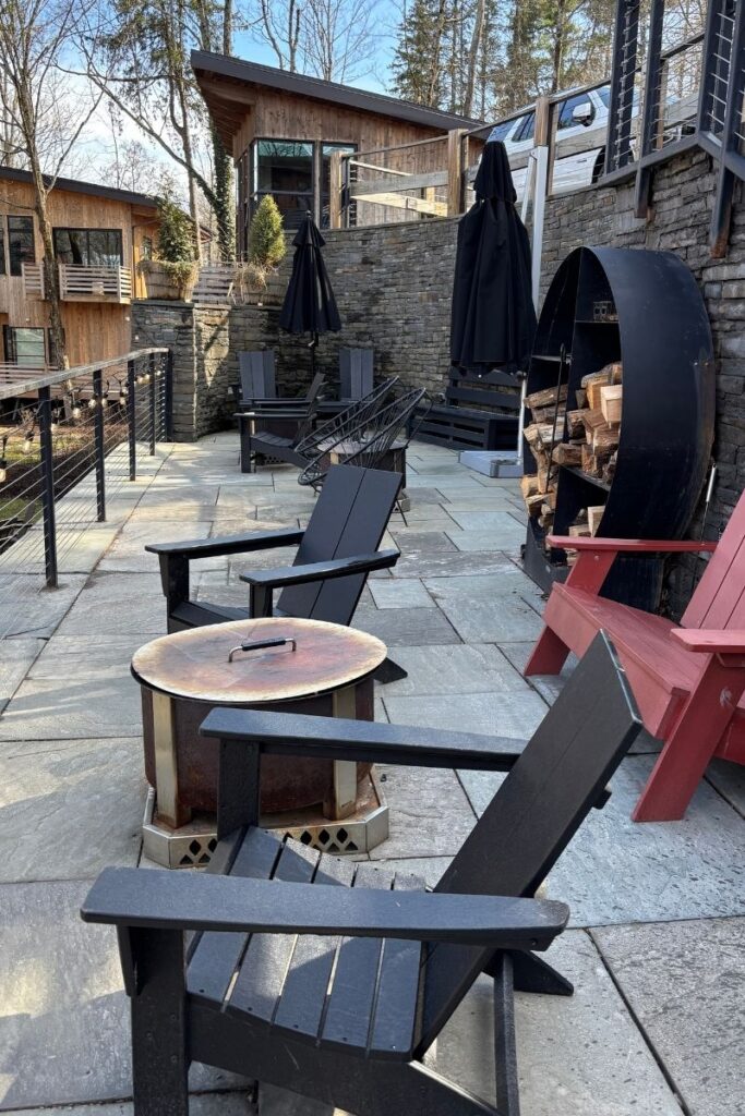 Firepit and Adirondack chairs on a stone patio
