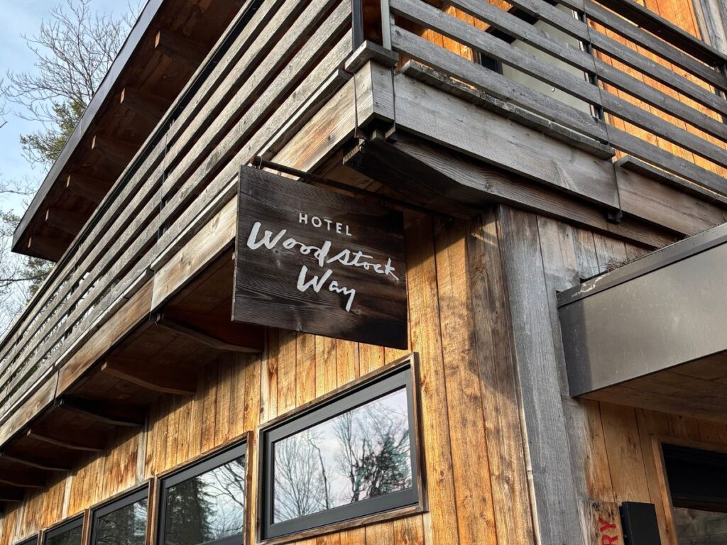 Rustic wooden sign for Hotel Woodstock Way at the entrance to the property, Woodstock, NY