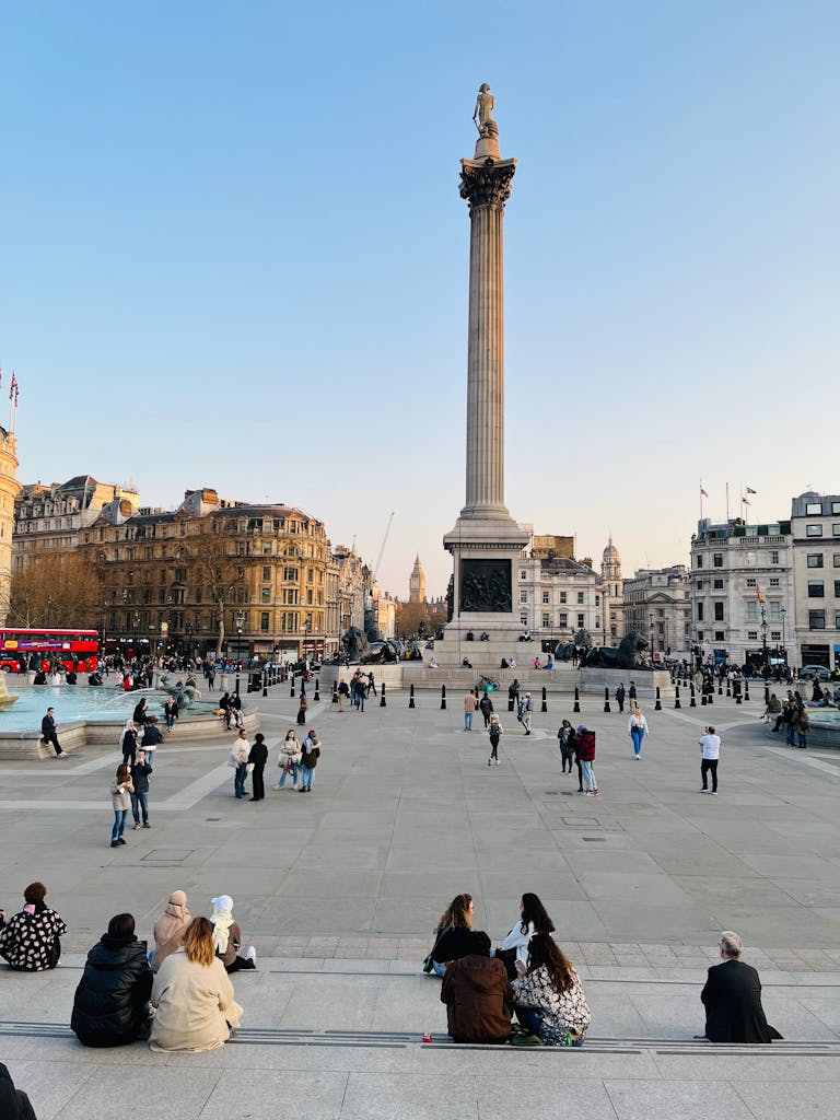 A vibrant day at Trafalgar Square featuring Nelson's Column and visitors enjoying the iconic London landmark.