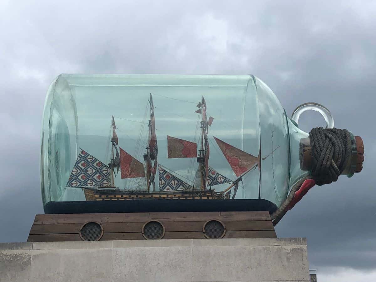 Nelson's Ship in a bottle against a cloudy backdrop at the National Maritime Museum in Greenwich.