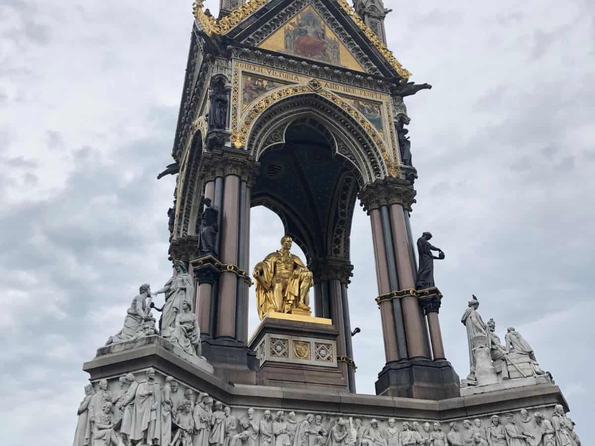 Prince Albert Memorial in London with gold statue at its center and decorative Victorian-era details surrounding it.