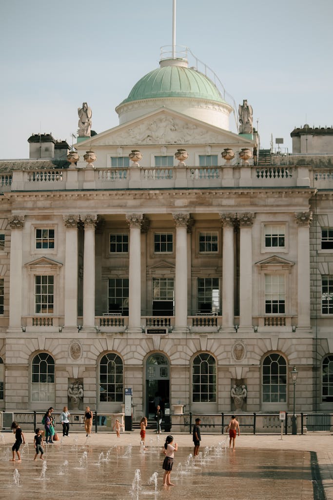 Somerset House in London, England, with visitors enjoying the fountains.