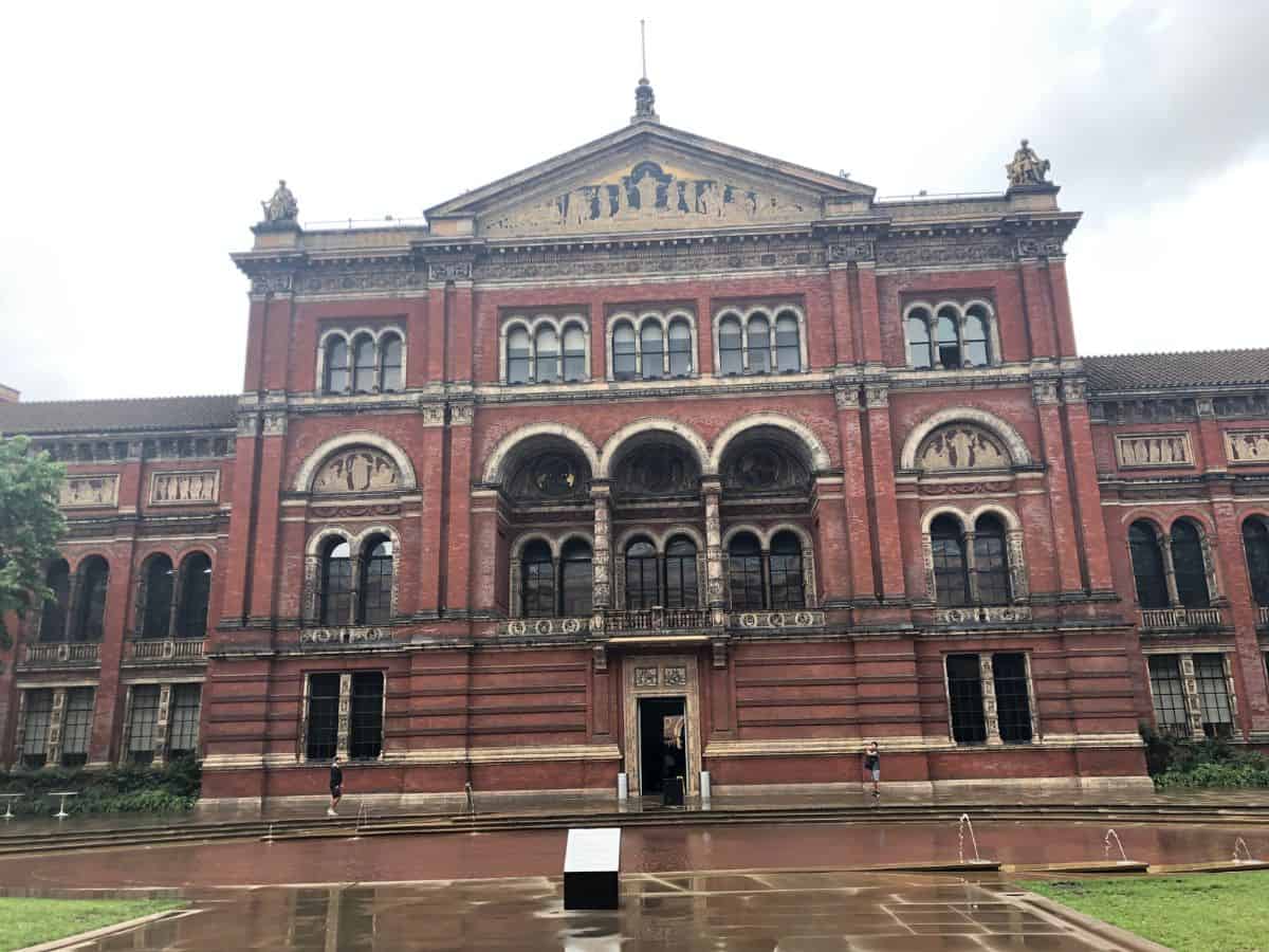 Interior courtyard view of the V&A museum with iconic red brick and ornate triple arch detail.