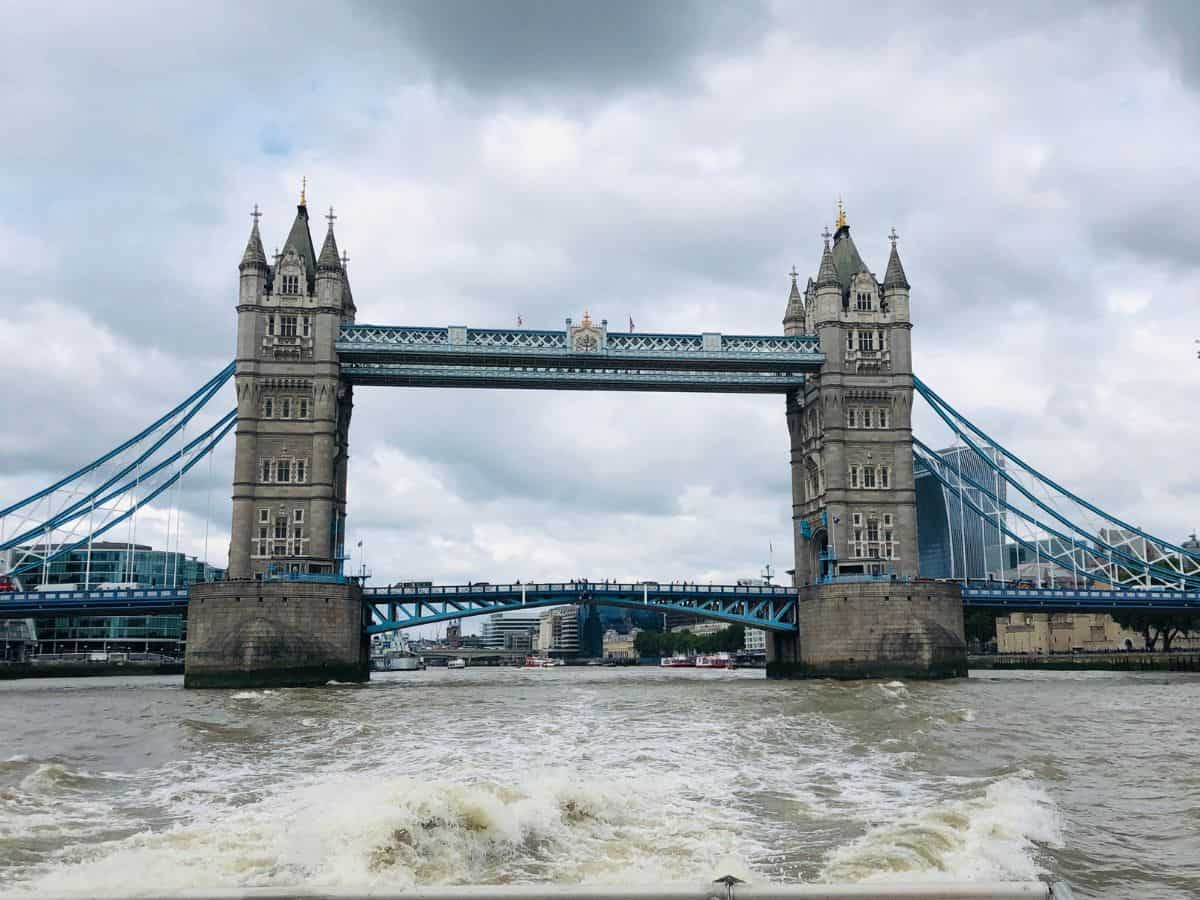 Tower Bridge as seen from deck of the Uber Boat by Thames Clippers as it passes east towards Greenwich on a cloudy day.