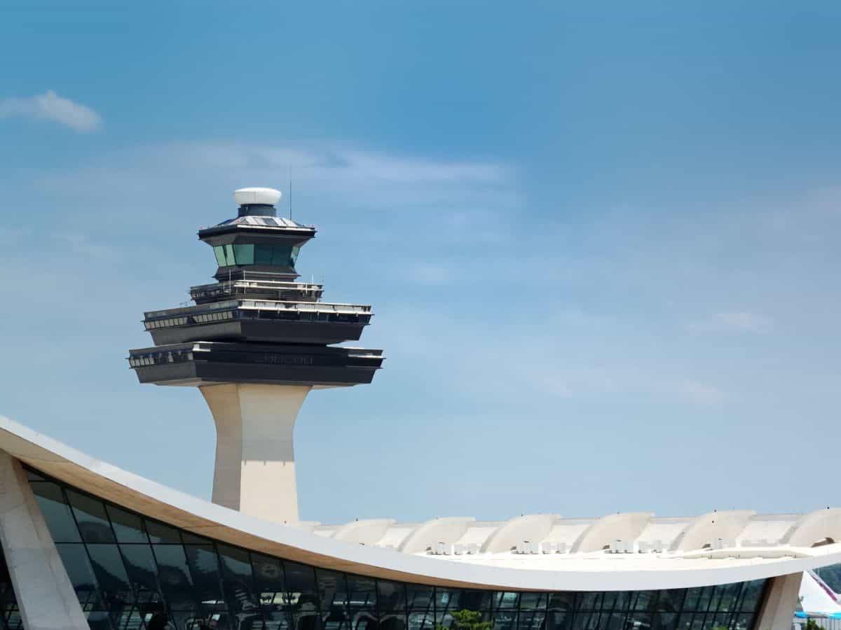 Air traffic control tower at Dulles International Airport just outside Washington DC as seen against a blue sky.